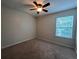 Bedroom with a neutral color scheme, carpeted floors and a window for natural light at 11800 Carriage Park Ln, Johns Creek, GA 30097