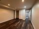 Bedroom featuring dark floors, a double door closet, and access to another room at 11800 Carriage Park Ln, Johns Creek, GA 30097