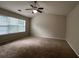 Spacious bedroom with large window and ceiling fan at 11800 Carriage Park Ln, Johns Creek, GA 30097