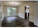 Dining room features dark wood-look floors, decorative wainscoting, and modern lighting at 11800 Carriage Park Ln, Johns Creek, GA 30097