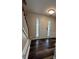 Inviting foyer with wood-look flooring and a bright white front door with side windows at 11800 Carriage Park Ln, Johns Creek, GA 30097