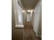 Upstairs hallway with carpet and white doors at 11800 Carriage Park Ln, Johns Creek, GA 30097