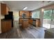Bright kitchen with stainless steel appliances, center island, wood cabinets, and deck access at 11800 Carriage Park Ln, Johns Creek, GA 30097