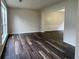 Bright living room with dark wood-look floors and abundant natural light at 11800 Carriage Park Ln, Johns Creek, GA 30097