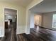 Open-concept living space showcasing wood-look floors and a seamless flow between rooms at 11800 Carriage Park Ln, Johns Creek, GA 30097