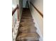 Carpeted staircase with wooden handrail and white trim at 11800 Carriage Park Ln, Johns Creek, GA 30097