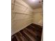 Walk-in closet with wire shelving and dark, wood-look floors at 11800 Carriage Park Ln, Johns Creek, GA 30097
