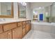 Bathroom featuring a double vanity, large mirrors and a tiled tub at 1160 Newpark View Pl # 8, Mableton, GA 30126