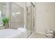 Bright bathroom featuring a glass shower, soaking tub, and neutral tile at 1160 Newpark View Pl # 8, Mableton, GA 30126