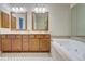 Bathroom featuring a double vanity, large mirrors and a tiled tub at 1160 Newpark View Pl # 8, Mableton, GA 30126