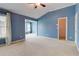 Spacious bedroom featuring blue walls, neutral carpet, large windows and ensuite at 1160 Newpark View Pl # 8, Mableton, GA 30126