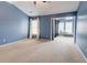 Spacious bedroom featuring blue walls, neutral carpet and large windows at 1160 Newpark View Pl # 8, Mableton, GA 30126
