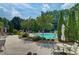 Community pool featuring lounge areas and surrounded by trees at 1160 Newpark View Pl # 8, Mableton, GA 30126
