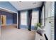 Bright sitting room with blue walls, curtains, windows and a cushioned bench at 1160 Newpark View Pl # 8, Mableton, GA 30126