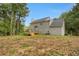 View of backyard from home's exterior with a large deck and lush greenery at 140 Heritage Ct, Fayetteville, GA 30214