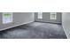 This comfortable bedroom has gray carpet and windows that let in plenty of natural light at 140 Heritage Ct, Fayetteville, GA 30214