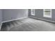 Carpeted bedroom with neutral paint, base trim and filled with light from the two windows at 140 Heritage Ct, Fayetteville, GA 30214