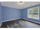 Comfortable bedroom features gray carpet, blue walls, and natural light from the window at 140 Heritage Ct, Fayetteville, GA 30214