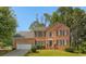 Charming two-story brick home with manicured lawn and attached two car garage at 140 Heritage Ct, Fayetteville, GA 30214