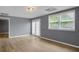 Comfortable living room has French doors that lead to the back and a large window at 140 Heritage Ct, Fayetteville, GA 30214