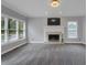 Living room featuring a cozy fireplace, large windows, and neutral carpet at 140 Heritage Ct, Fayetteville, GA 30214