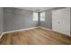 Living room with light-colored hardwood floors, neutral walls, and double windows at 140 Heritage Ct, Fayetteville, GA 30214