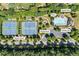 Aerial view of neighborhood amenities including tennis court, playground, splash pad, and a community pool at 3843 Dragon Fly Ln, Loganville, GA 30052