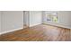 Bedroom boasts wood-look flooring, neutral walls, natural light, and access to an adjacent room at 3843 Dragon Fly Ln, Loganville, GA 30052