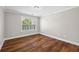 Cozy bedroom with hardwood floors, large window with outdoor views, and neutral paint at 3843 Dragon Fly Ln, Loganville, GA 30052