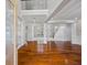 Grand entrance foyer with dark wood floors, columns, and detailed trim work at 3843 Dragon Fly Ln, Loganville, GA 30052
