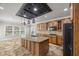 Well-appointed kitchen featuring granite counters, an island with sink, and stainless appliances at 3843 Dragon Fly Ln, Loganville, GA 30052