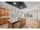 Bright, open kitchen with an island, a view of the stairs, and stainless steel appliances at 3843 Dragon Fly Ln, Loganville, GA 30052