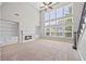 Bright living room featuring a cozy fireplace, built-in shelving, and lots of natural light at 3843 Dragon Fly Ln, Loganville, GA 30052