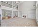 Spacious living area with fireplace, soaring ceiling, built-in shelving, and hardwood floors at 3843 Dragon Fly Ln, Loganville, GA 30052