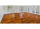 Open living area with hardwood floors, wainscoting, and large windows at 3843 Dragon Fly Ln, Loganville, GA 30052