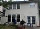 Exterior backyard view of a multi-story home, featuring a patio with outdoor cooking setup at 4018 Carisbrook Dr, Union City, GA 30291