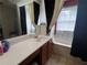 Bathroom features a single sink vanity, mirror, and a tub with black and white curtains at 4018 Carisbrook Dr, Union City, GA 30291