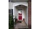 Inviting front entrance with a red door, brick accents, and traditional design elements at 4018 Carisbrook Dr, Union City, GA 30291