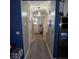 Well-lit hallway with neutral walls, modern lighting, and durable flooring at 4018 Carisbrook Dr, Union City, GA 30291