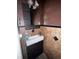 Modern powder room with a sleek vanity, accent mirror, and decorative tile at 4018 Carisbrook Dr, Union City, GA 30291