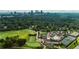 Stunning aerial view of golf course, pool, tennis courts and the city skyline in the background at 2466 Brookhaven Ne Pl, Brookhaven, GA 30319
