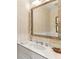 Powder room with a large framed mirror and a white vanity at 2466 Brookhaven Ne Pl, Brookhaven, GA 30319