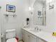 Well-lit bathroom featuring white cabinetry, elegant fixtures, and a framed photograph on the wall at 2466 Brookhaven Ne Pl, Brookhaven, GA 30319