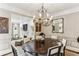 Formal dining room with chandelier, wainscoting and stylish decor, perfect for entertaining at 2466 Brookhaven Ne Pl, Brookhaven, GA 30319