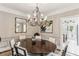 Elegant dining room with beautiful chandelier and views of adjacent kitchen at 2466 Brookhaven Ne Pl, Brookhaven, GA 30319