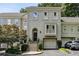 Elegant townhome exterior with a private garage and well-maintained landscaping at 2466 Brookhaven Ne Pl, Brookhaven, GA 30319