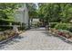 Secure gated entrance with cobblestone drive leading to the property, surrounded by lush landscaping at 2466 Brookhaven Ne Pl, Brookhaven, GA 30319
