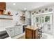 Bright eat-in kitchen with a butcher block island, white cabinetry, and stainless steel appliances at 2466 Brookhaven Ne Pl, Brookhaven, GA 30319
