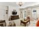 Cozy living room with a large TV, built-in cabinets, and a stylish patterned ottoman at 2466 Brookhaven Ne Pl, Brookhaven, GA 30319