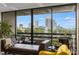 Balcony with city skyline views through large windows, accessible from the elegant living space at 2660 Peachtree Nw Rd # 13F, Atlanta, GA 30305